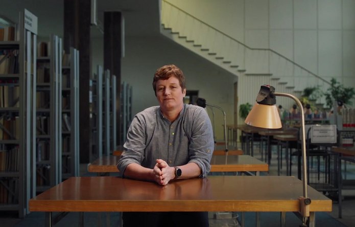 A female scientist sitting behind a desk